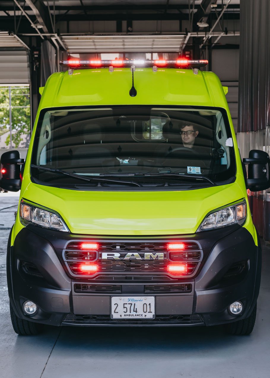 Stark County ambulance with emergency lighting active in a station bay