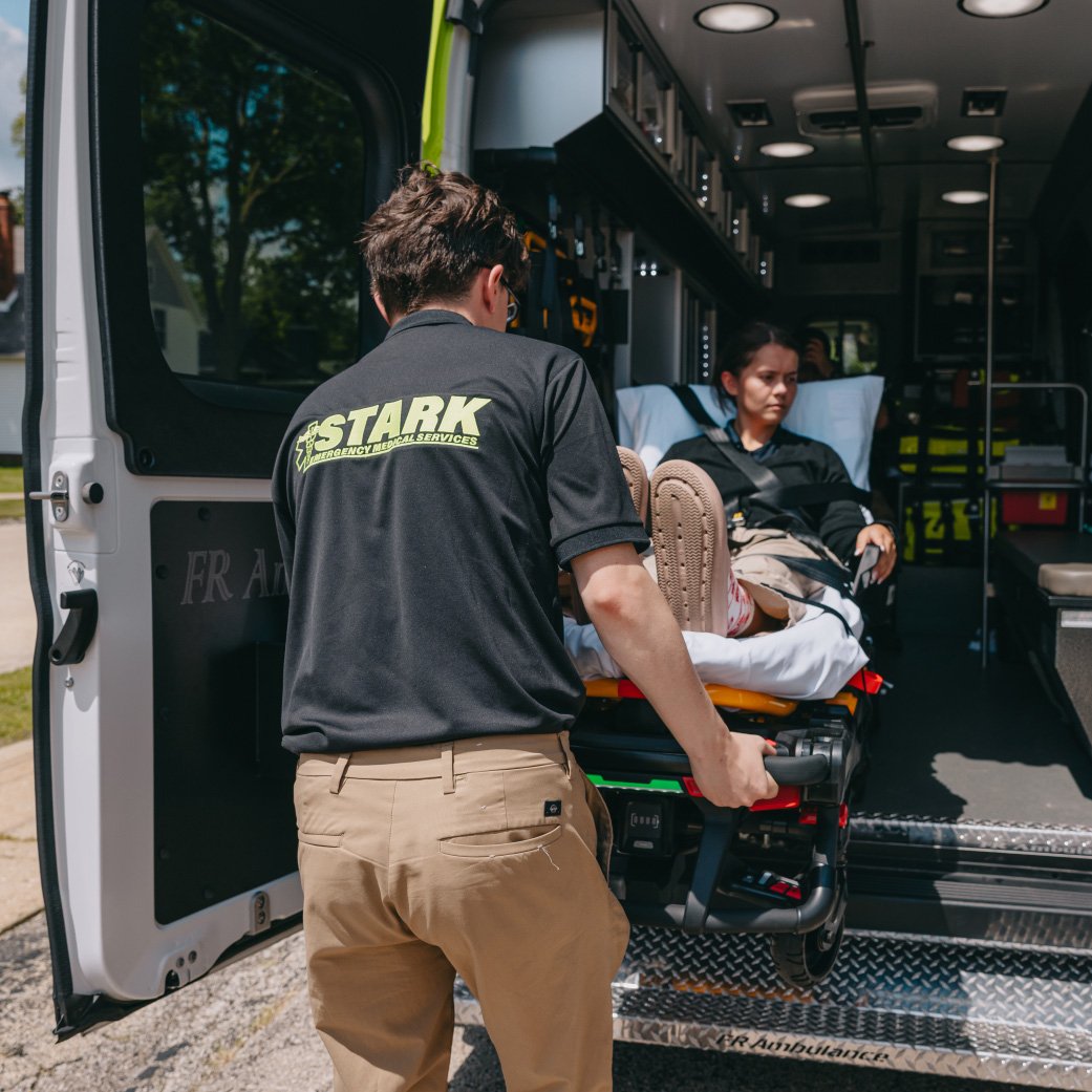 Stark County crew lifting a stretcher into the back of an ambulance