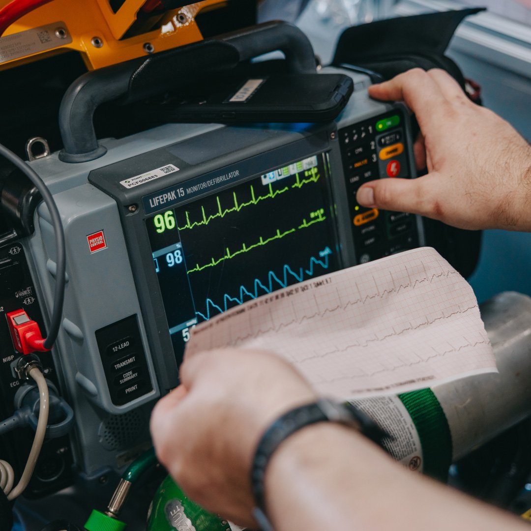 Paramedic checking patient vitals on a monitor in a Stark County ambulance