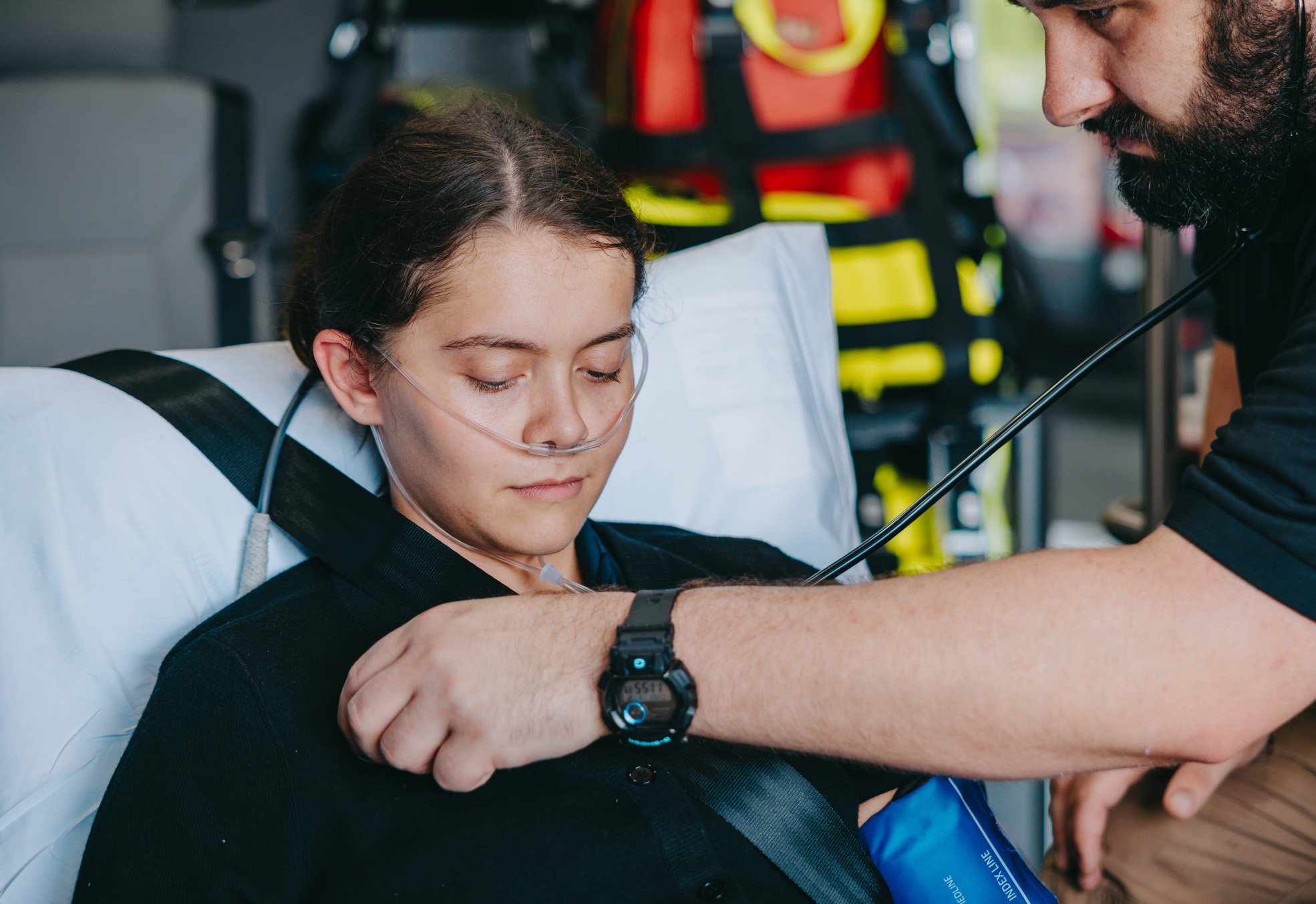 Stark County paramedic caring for a seated patient in an ambulance