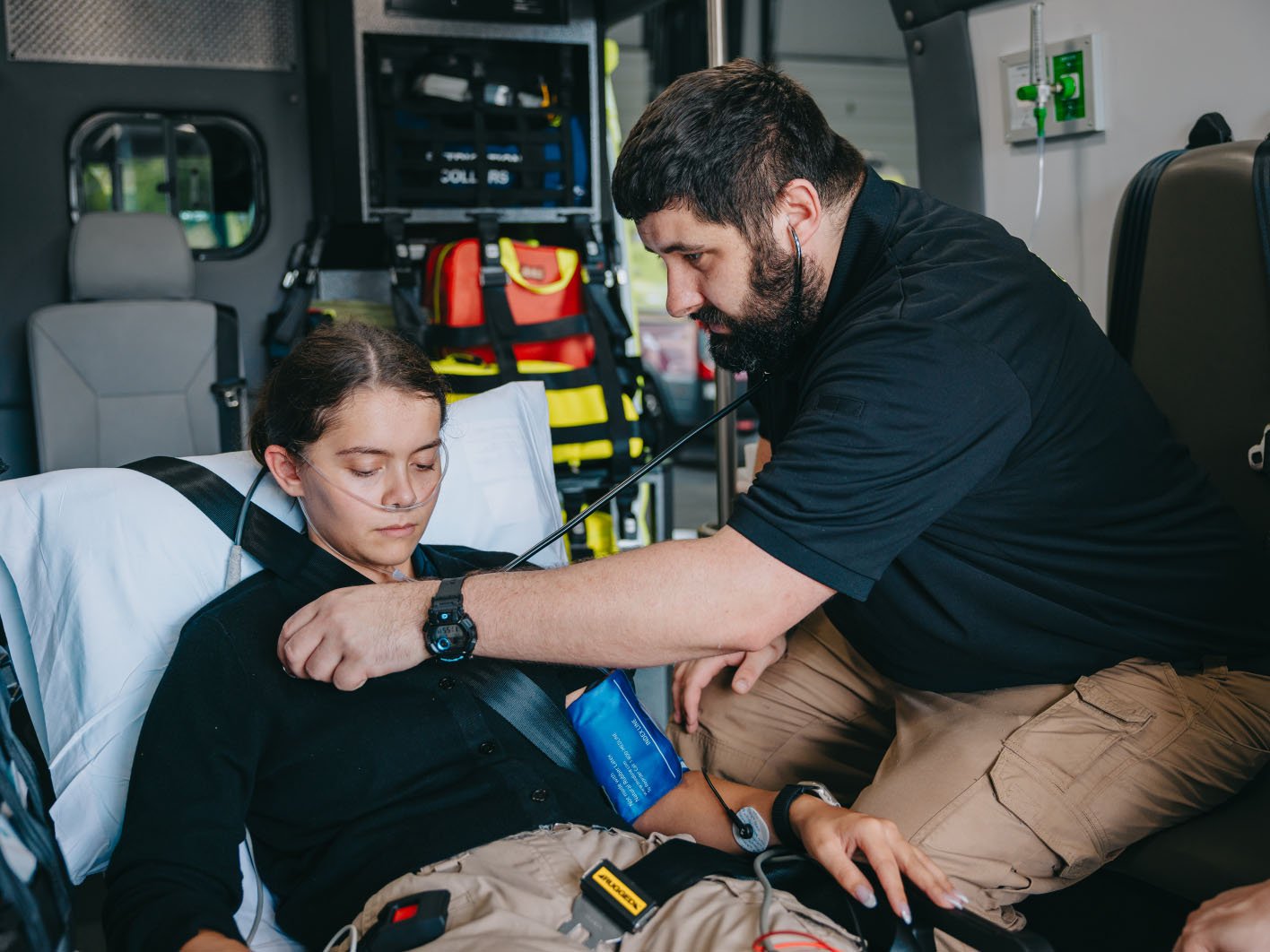 Stark County paramedic treating a patient during transport
