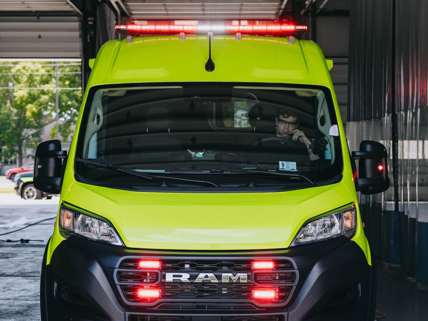 Stark County ambulance with emergency lighting active in a bay