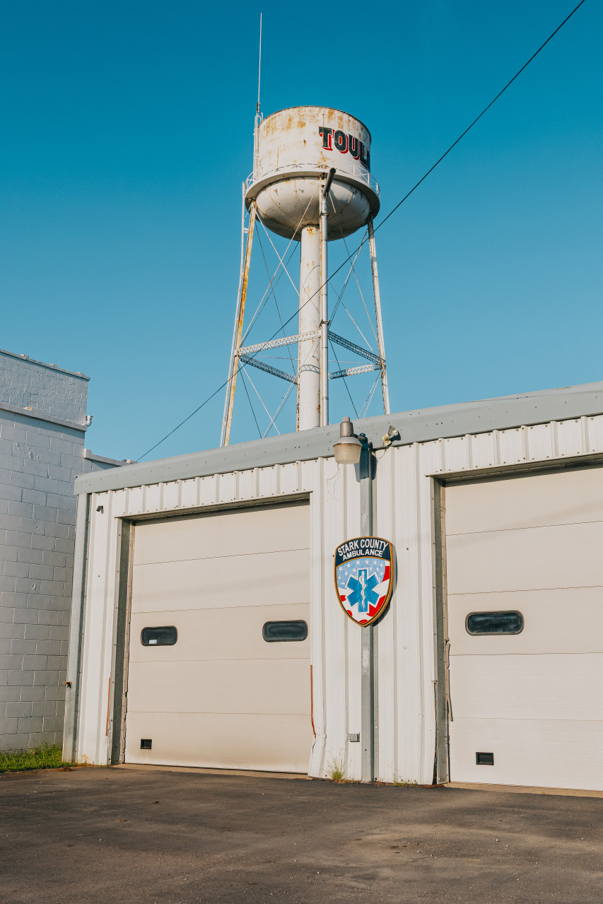 Stark County Ambulance Toulon station bays with the Toulon water tower overhead in Toulon, Illinois