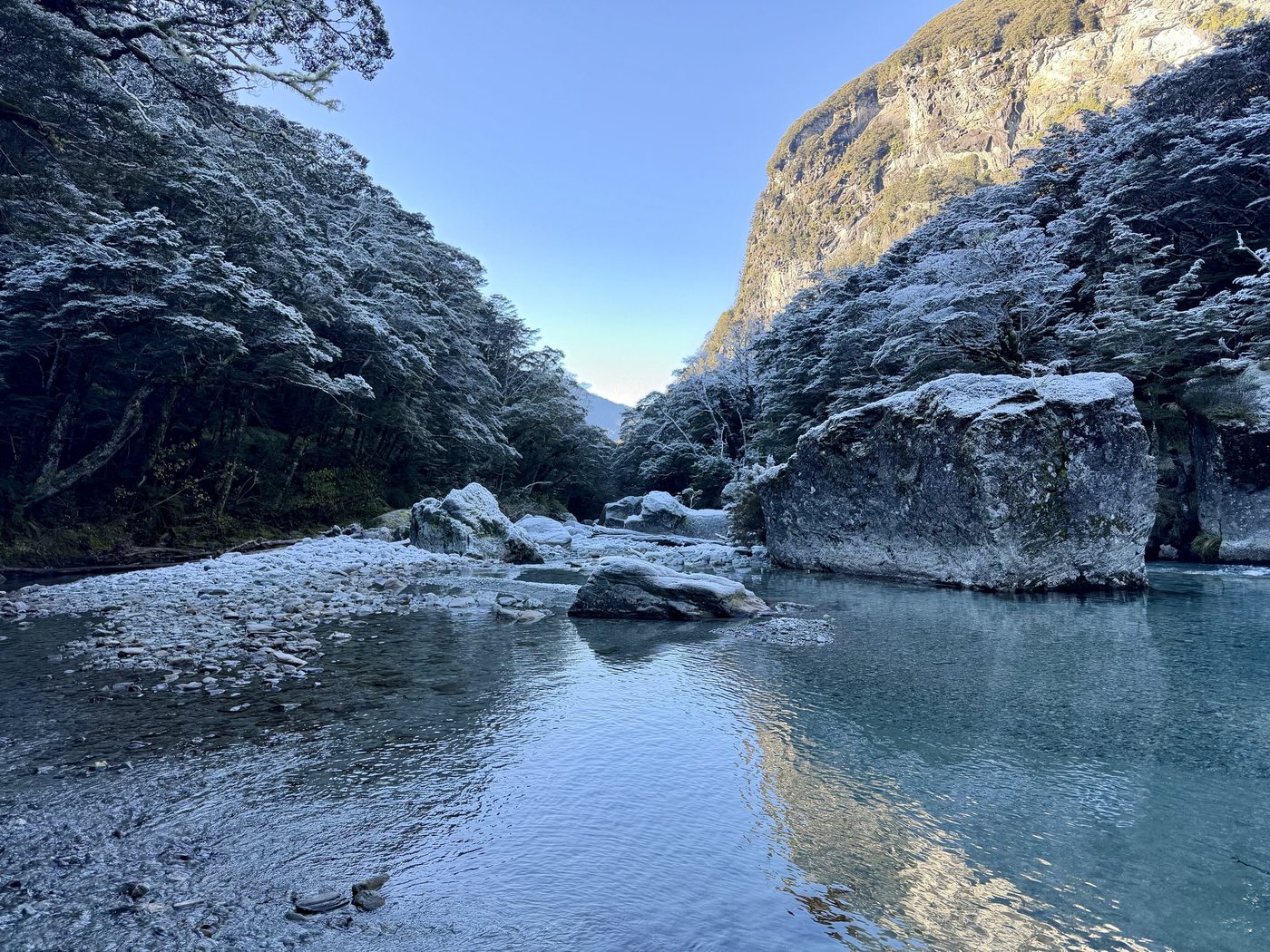A frosted gorge with a river running through it