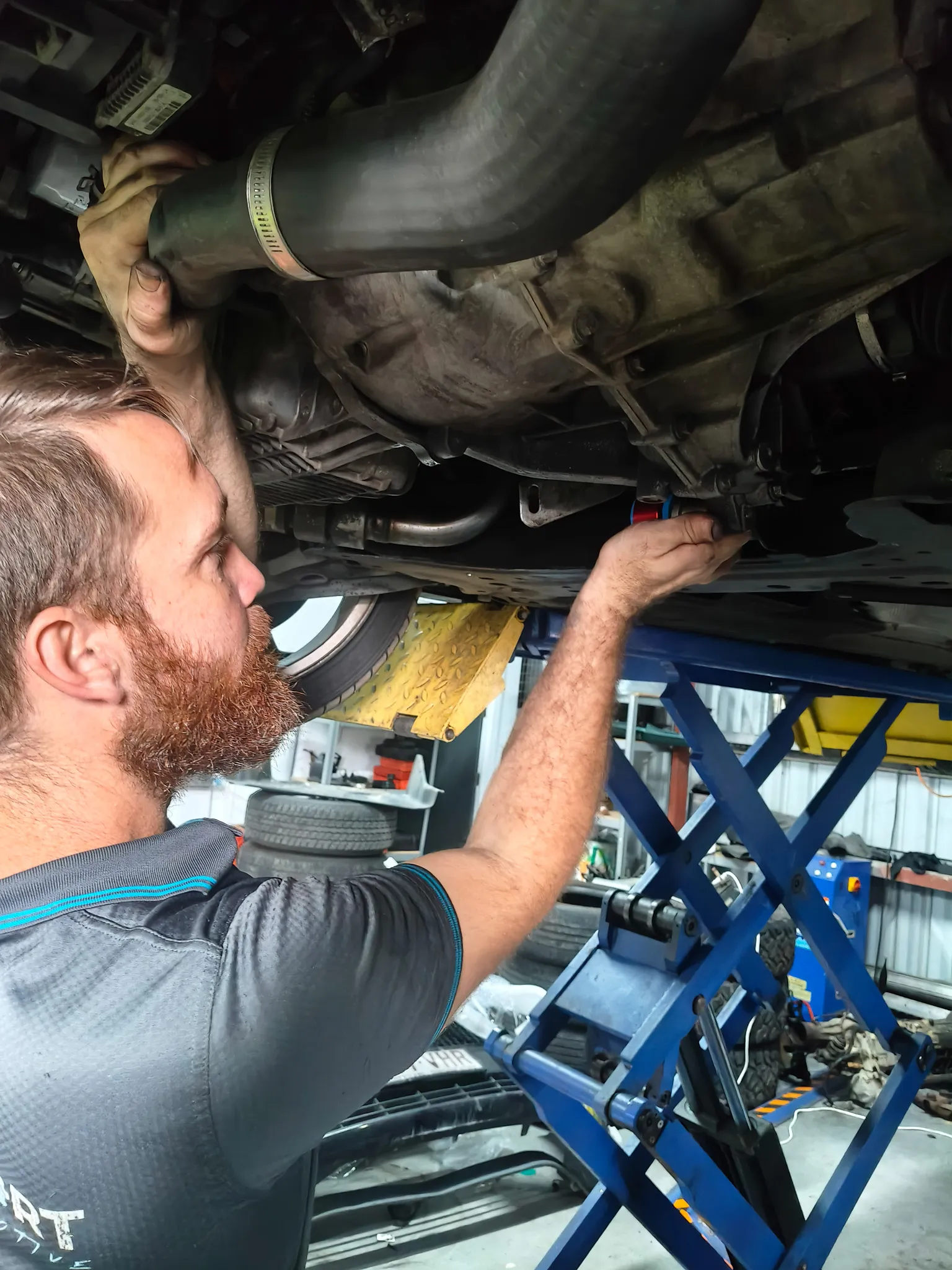 PajSport technician working on a Mitsubishi engine