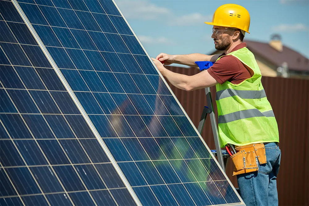 Worker on solar panel maintenance