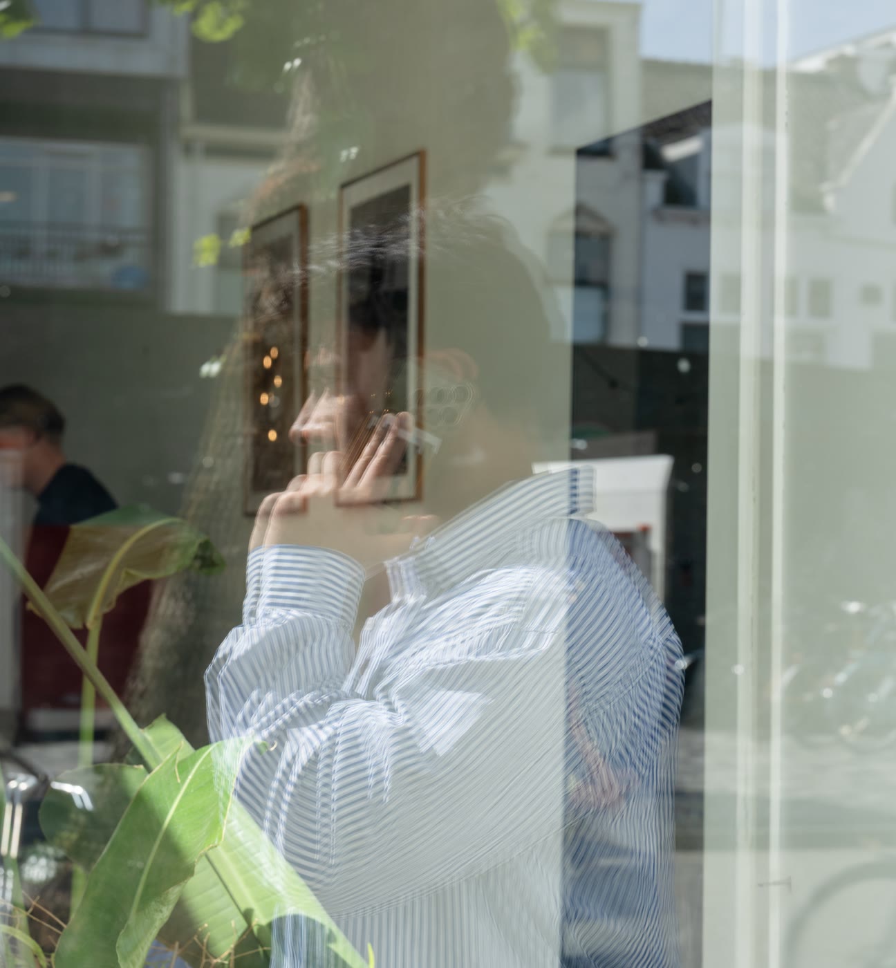 An Onpressive team member on the phone behind the studio window