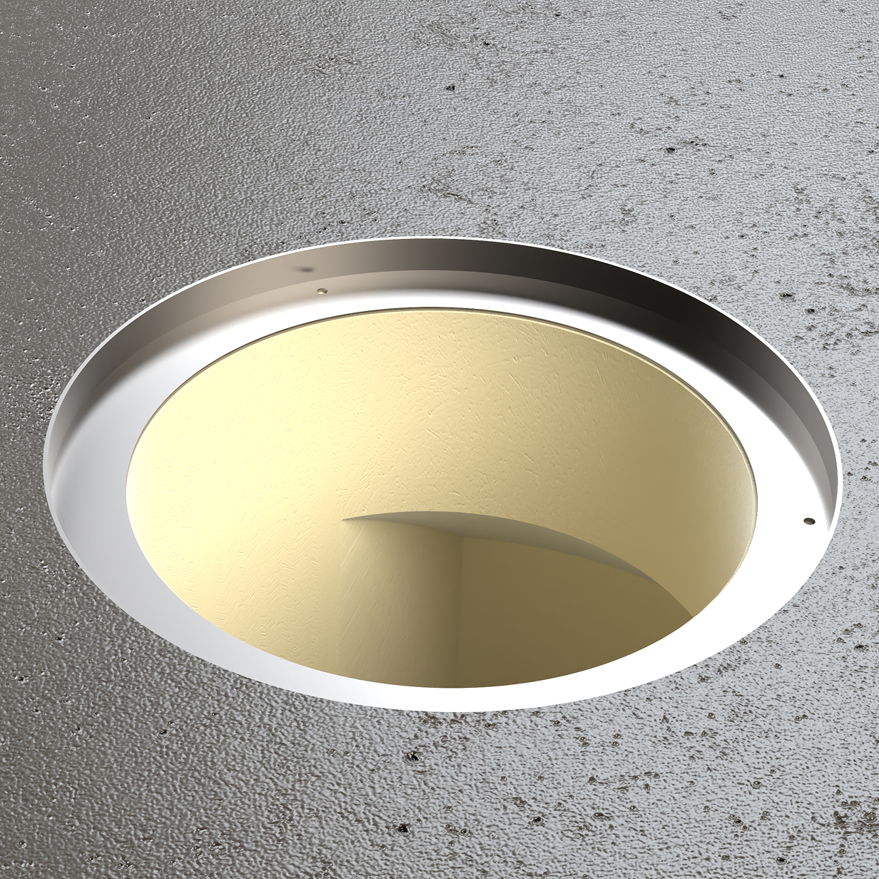Close-up of a circular metal flange mounted on a textured gray surface, featuring a smooth gold-colored inner lining.