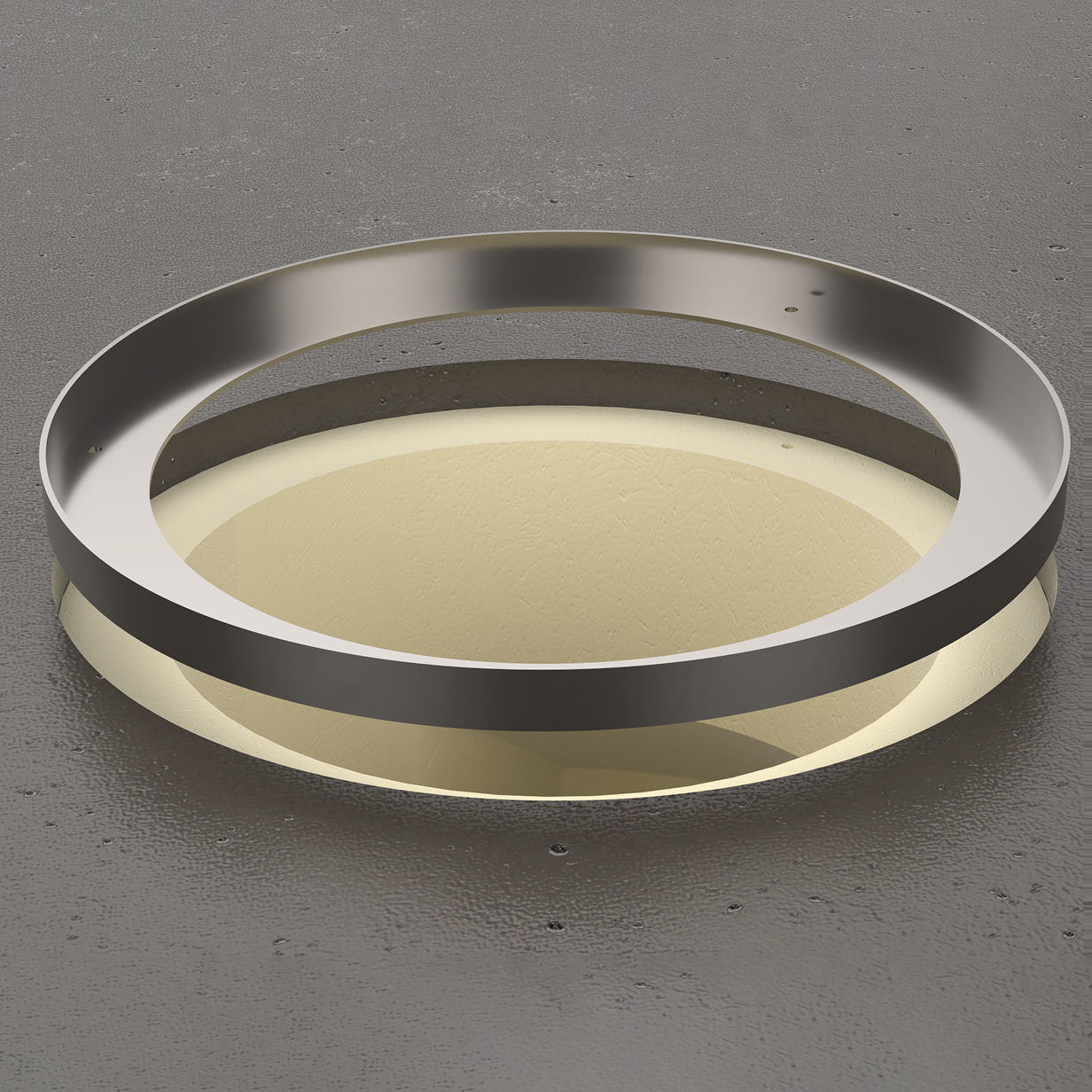 Circular metal flange placed above a round hole in a textured gray surface, showing the flange's hollow center and smooth metallic finish.
