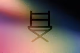 Silhouette of a director's chair with a colorful blurred gradient background.