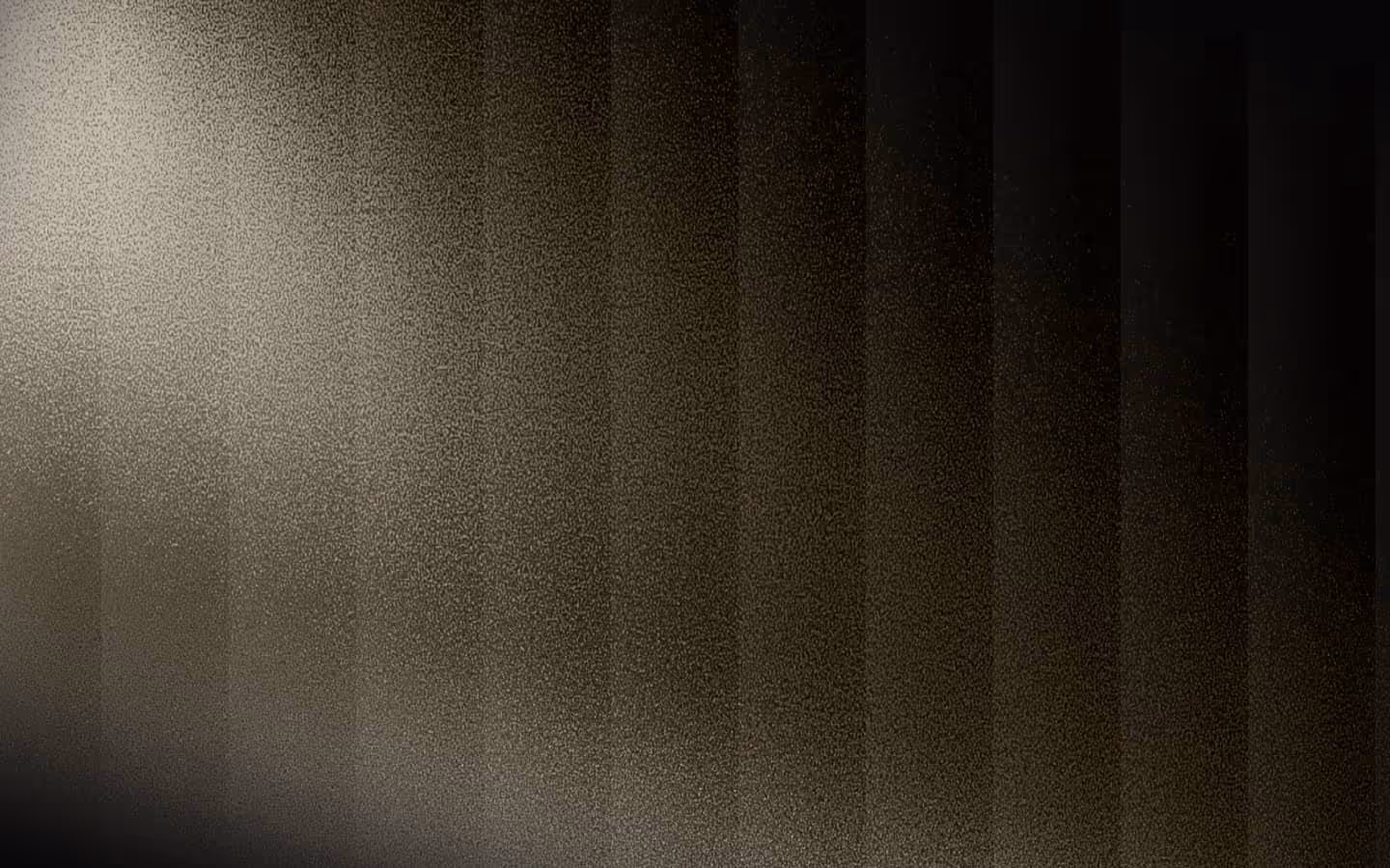 Abstract gradient pattern with vertical dark stripes fading into a granular texture from left to right.