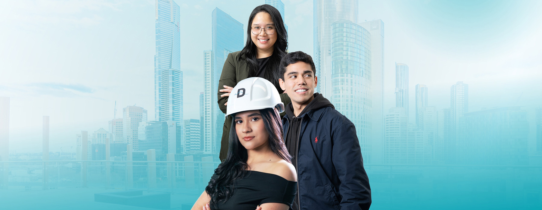 Three Danford College students, one holding a branded hard hat, with the Melbourne skyline behind them