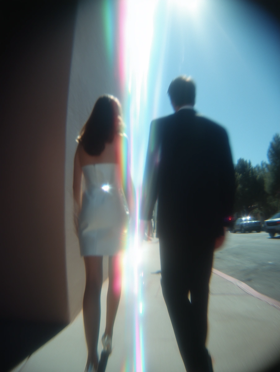 Woman walking through soft backlight in a dreamy outdoor scene.