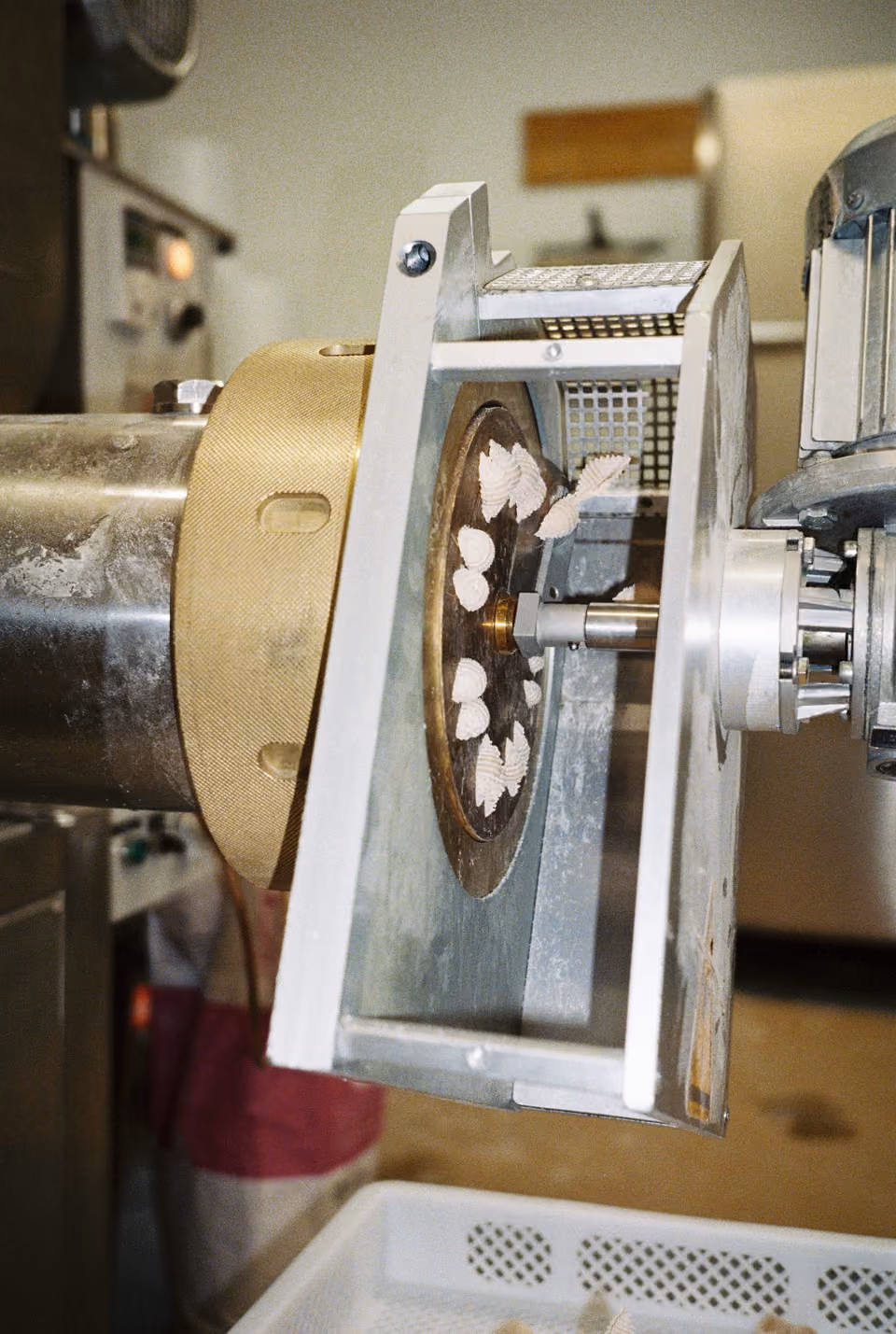 Close-up of an industrial pasta making machine.