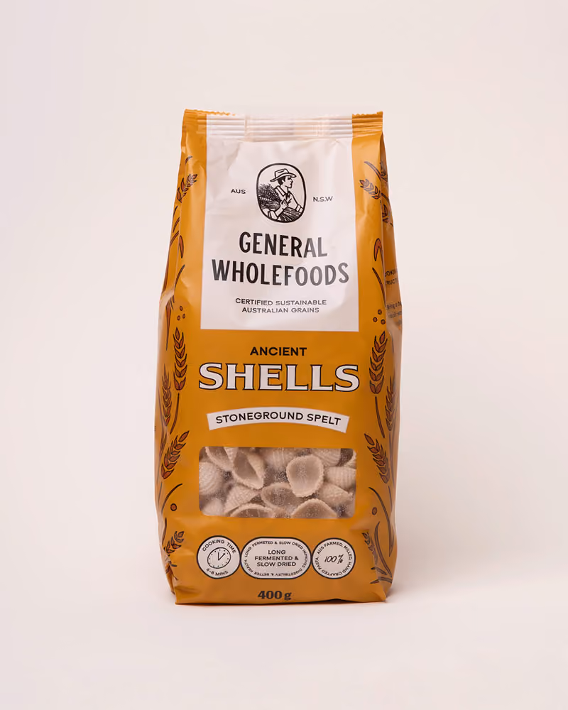 Package of General Wholefoods Ancient Shells stoneground spelt pasta with a window showing shell-shaped pasta inside.