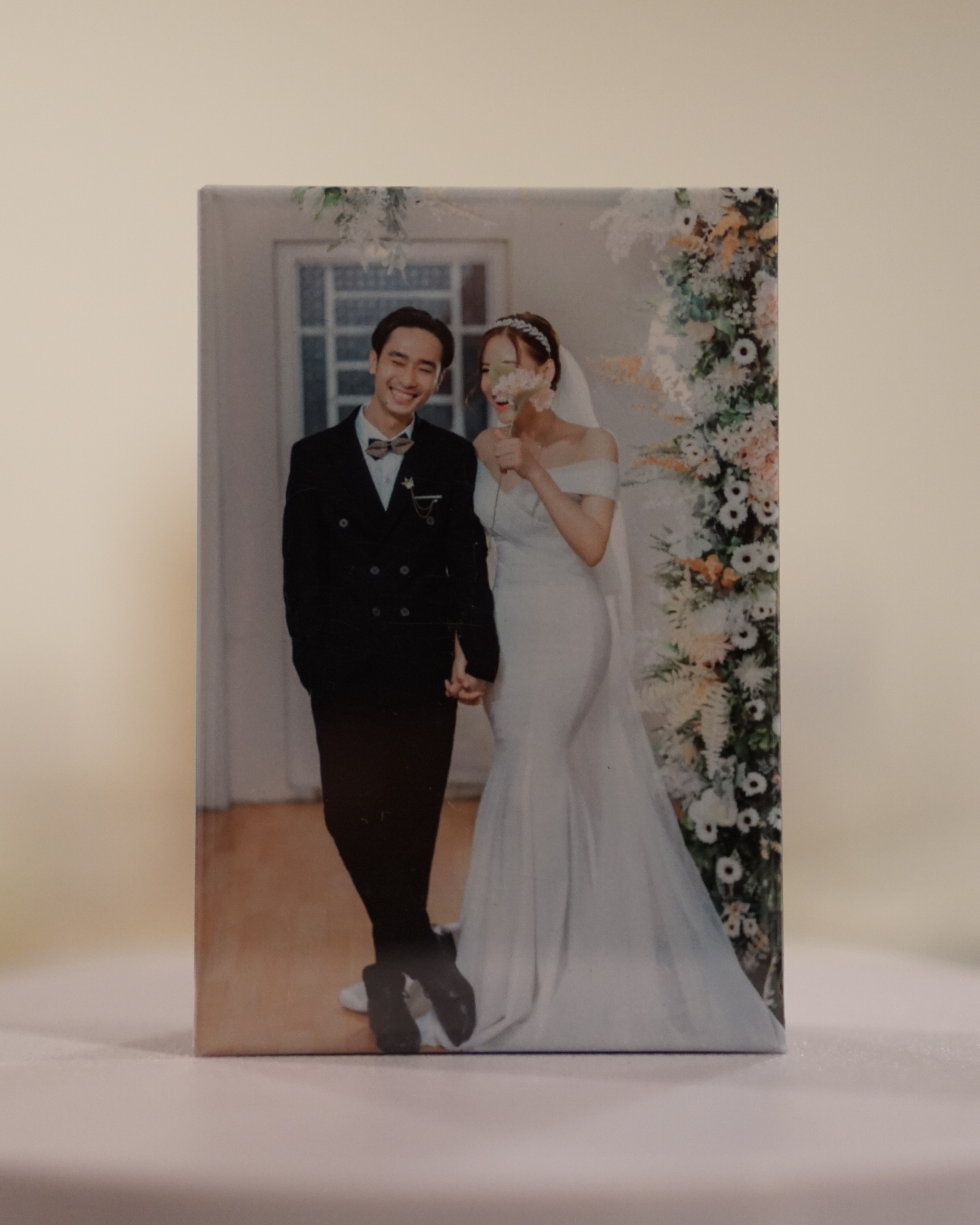 Guests using an on-site photo magnet booth at a wedding reception