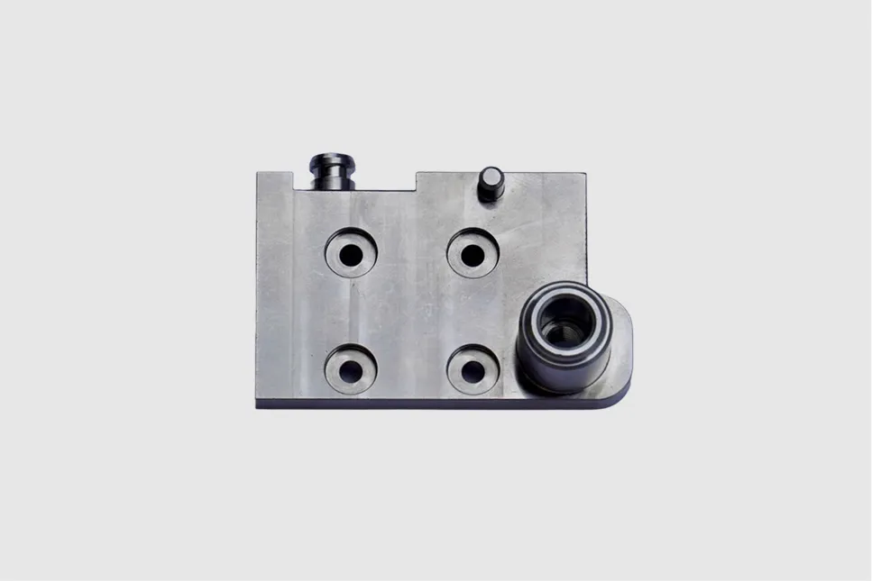 Precision-machined metal block with bearing and mounting holes