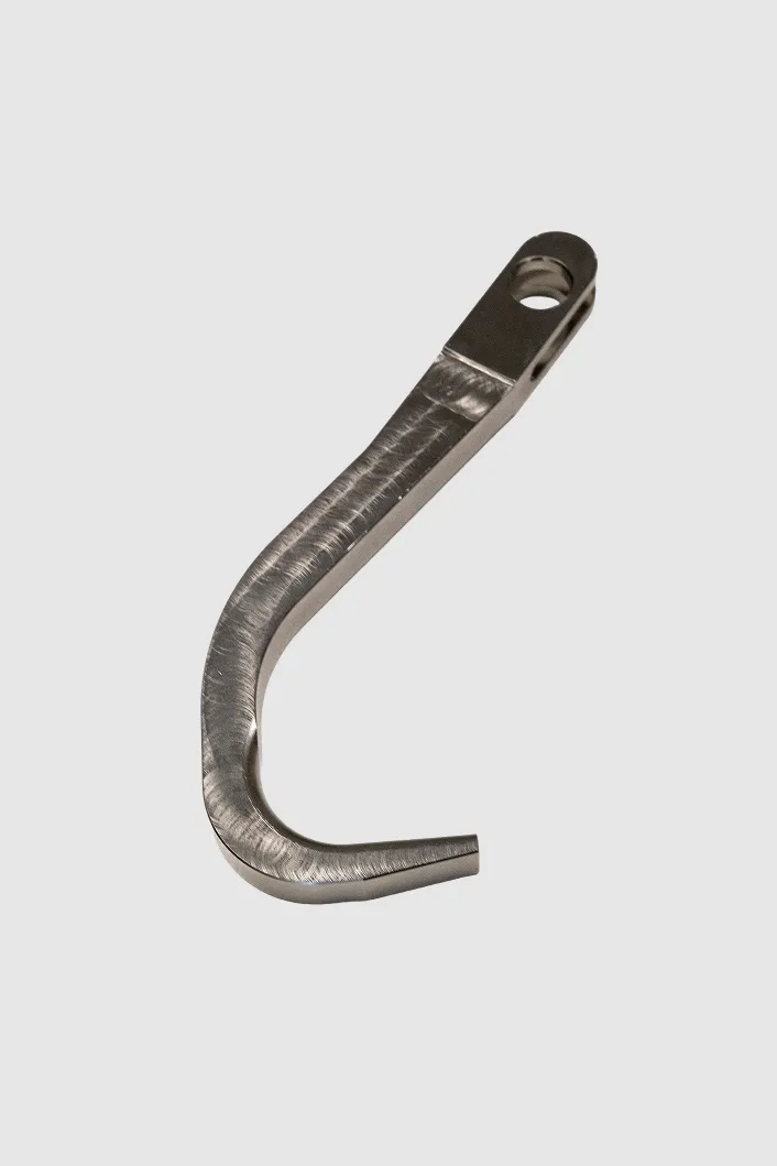 Curved machined metal part with mounting hole