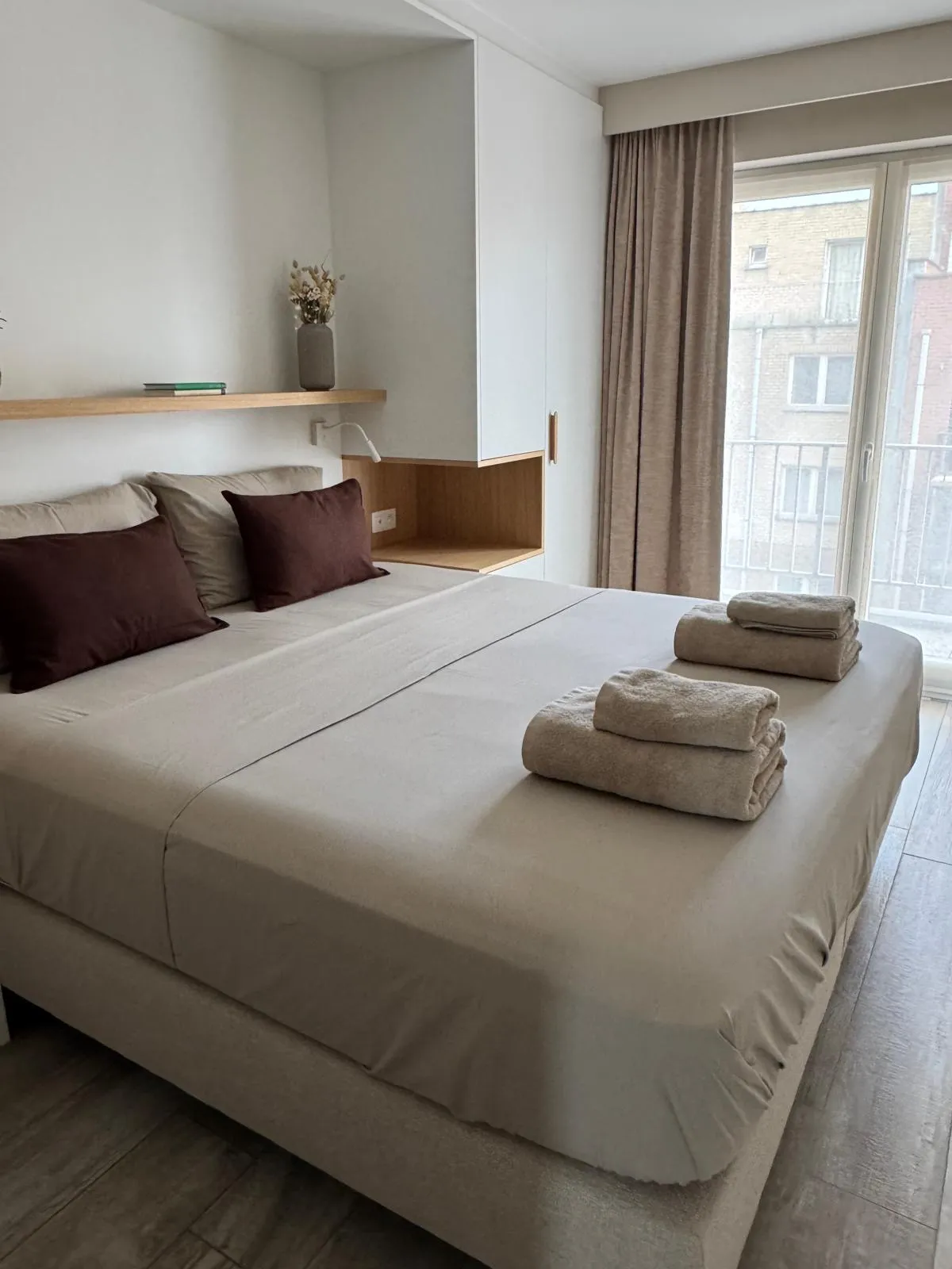 Opgemaakt bed met verse handdoeken, klaar voor de volgende huurders