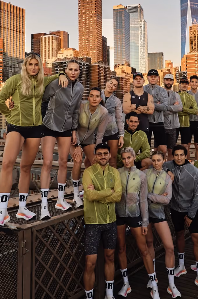the pace club crew on a bridge in front of the Manhattan skyline