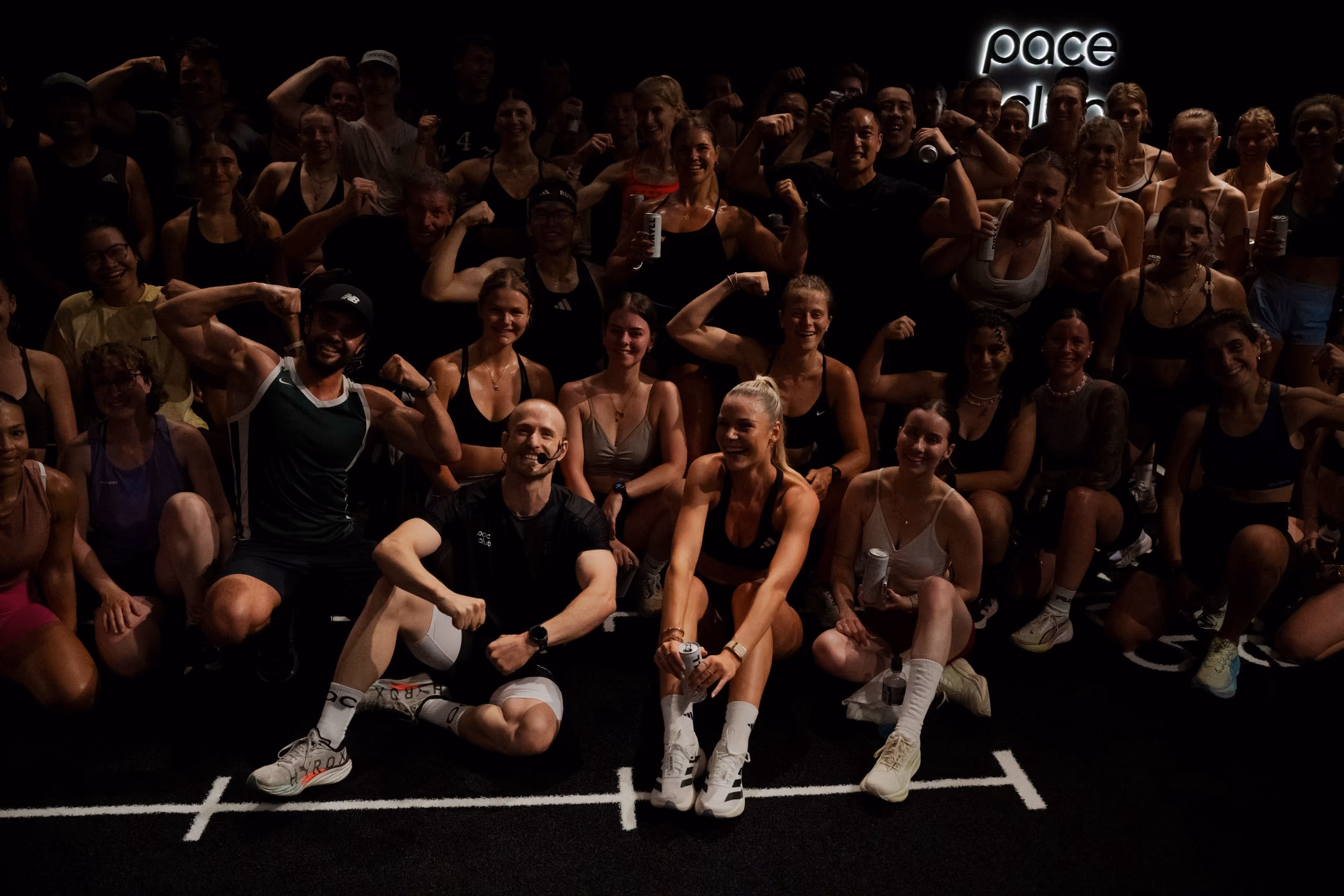the full crew posing under the pace club sign