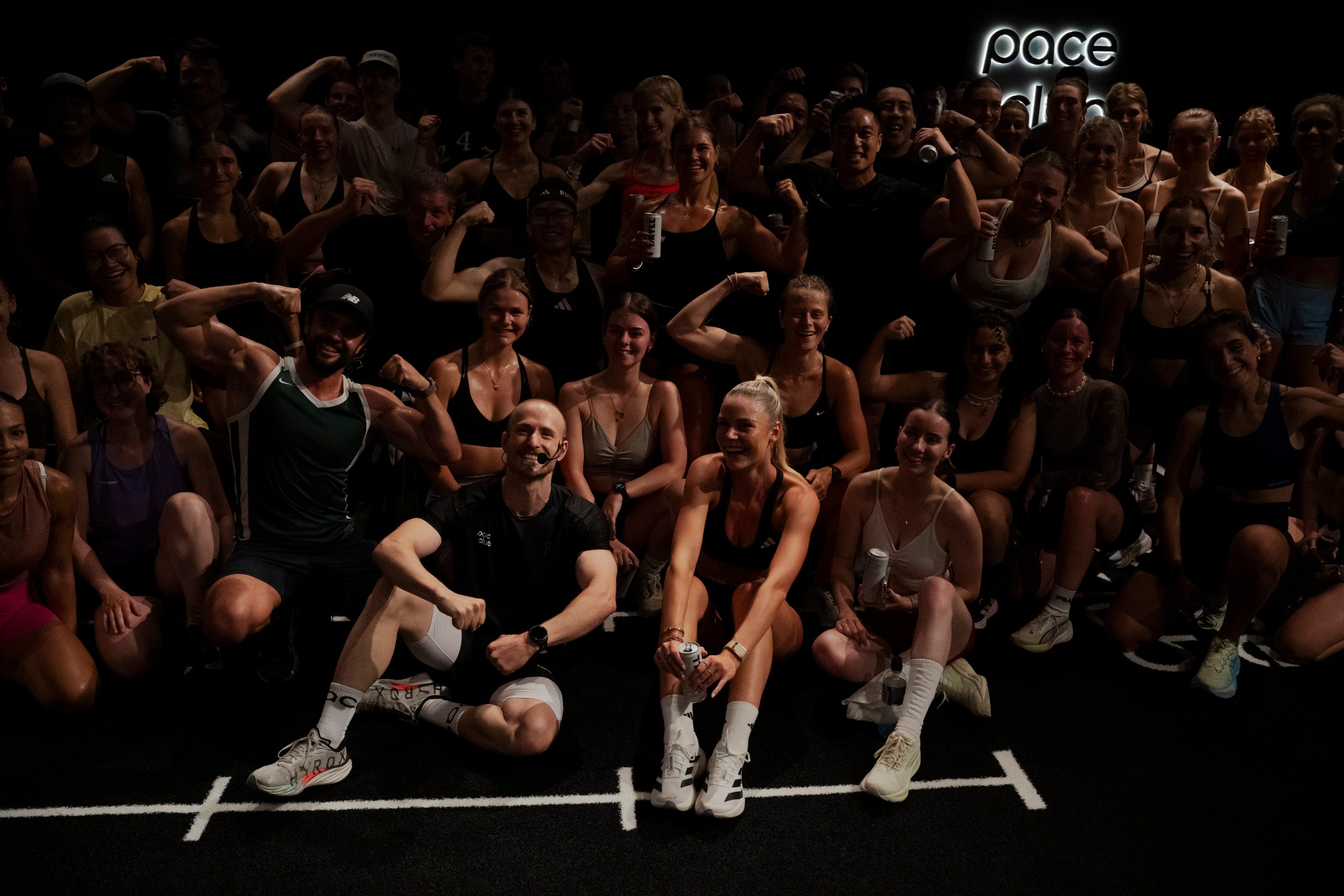 the full crew posing under the pace club sign