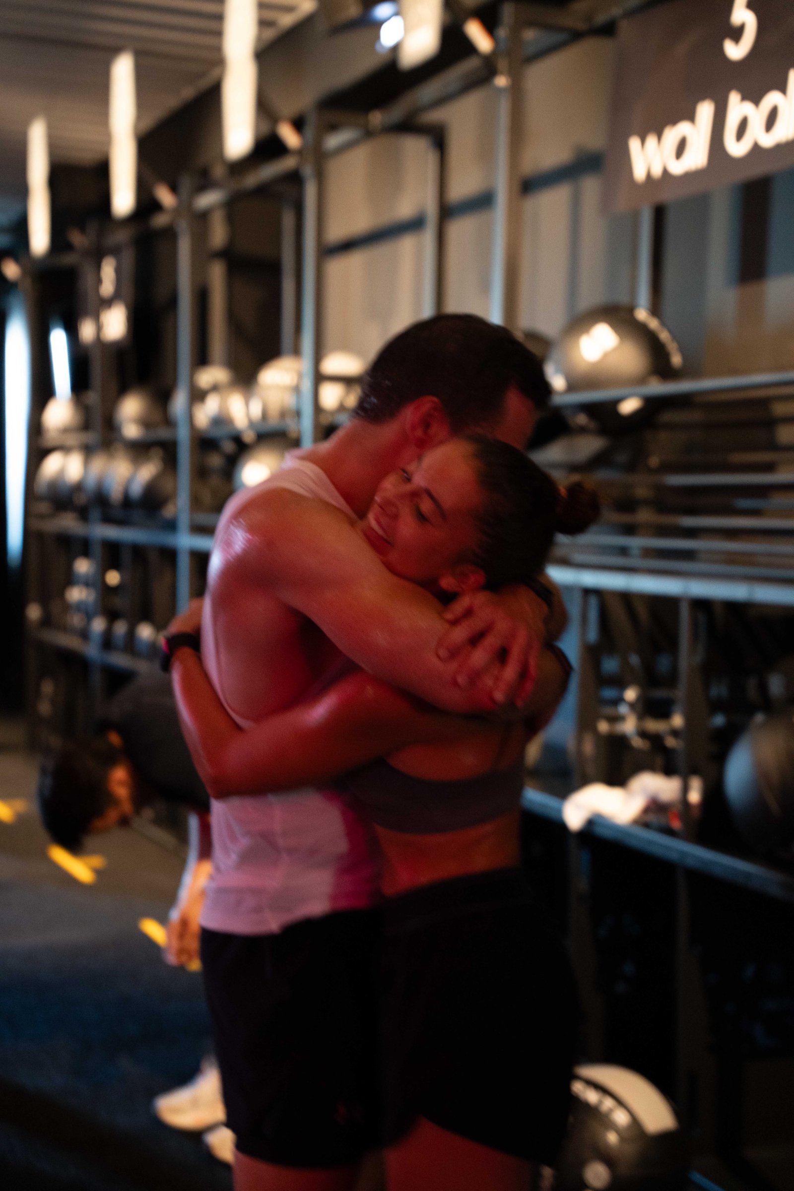 coach and athlete hugging after the session