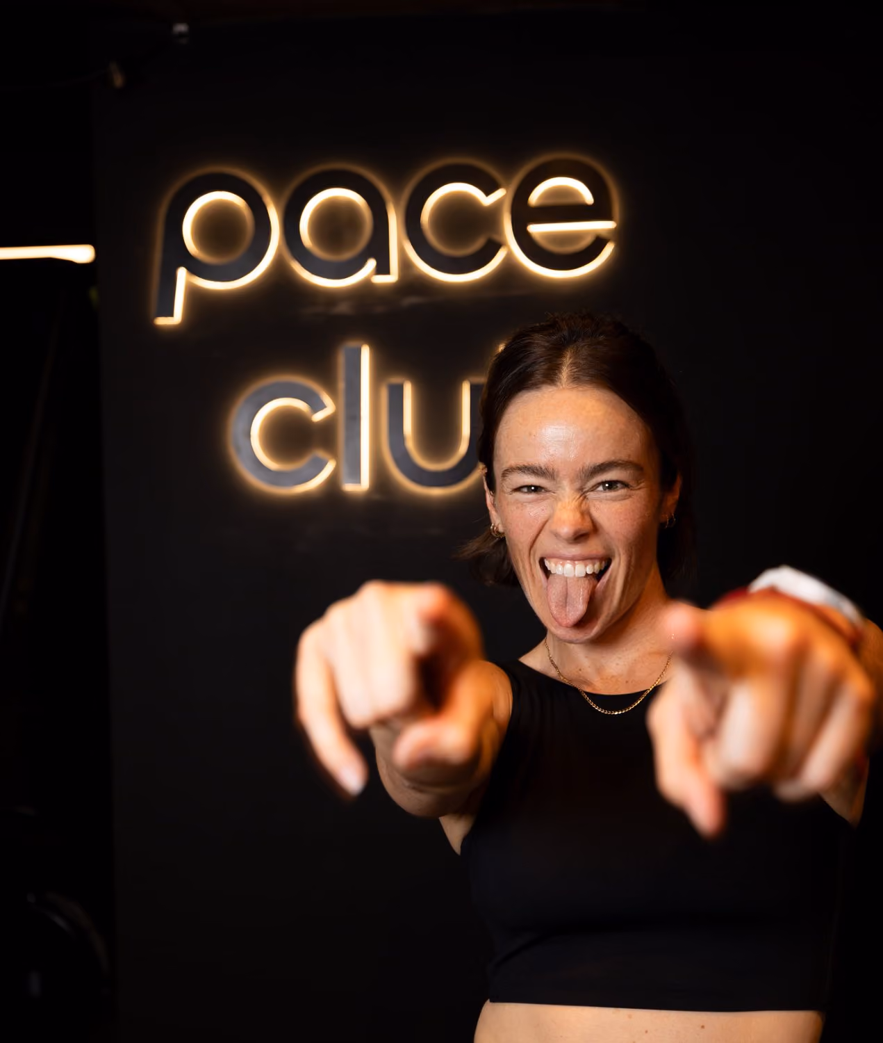 a coach in front of the pace club sign
