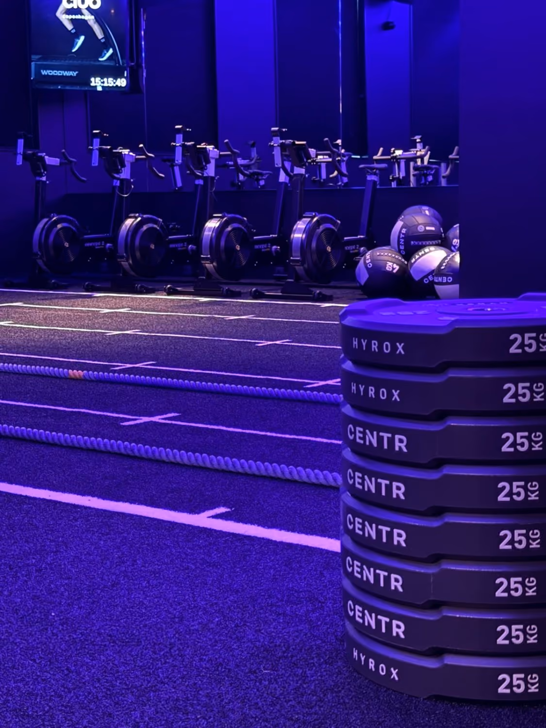 rowers, wall balls and a stack of 25 kg plates