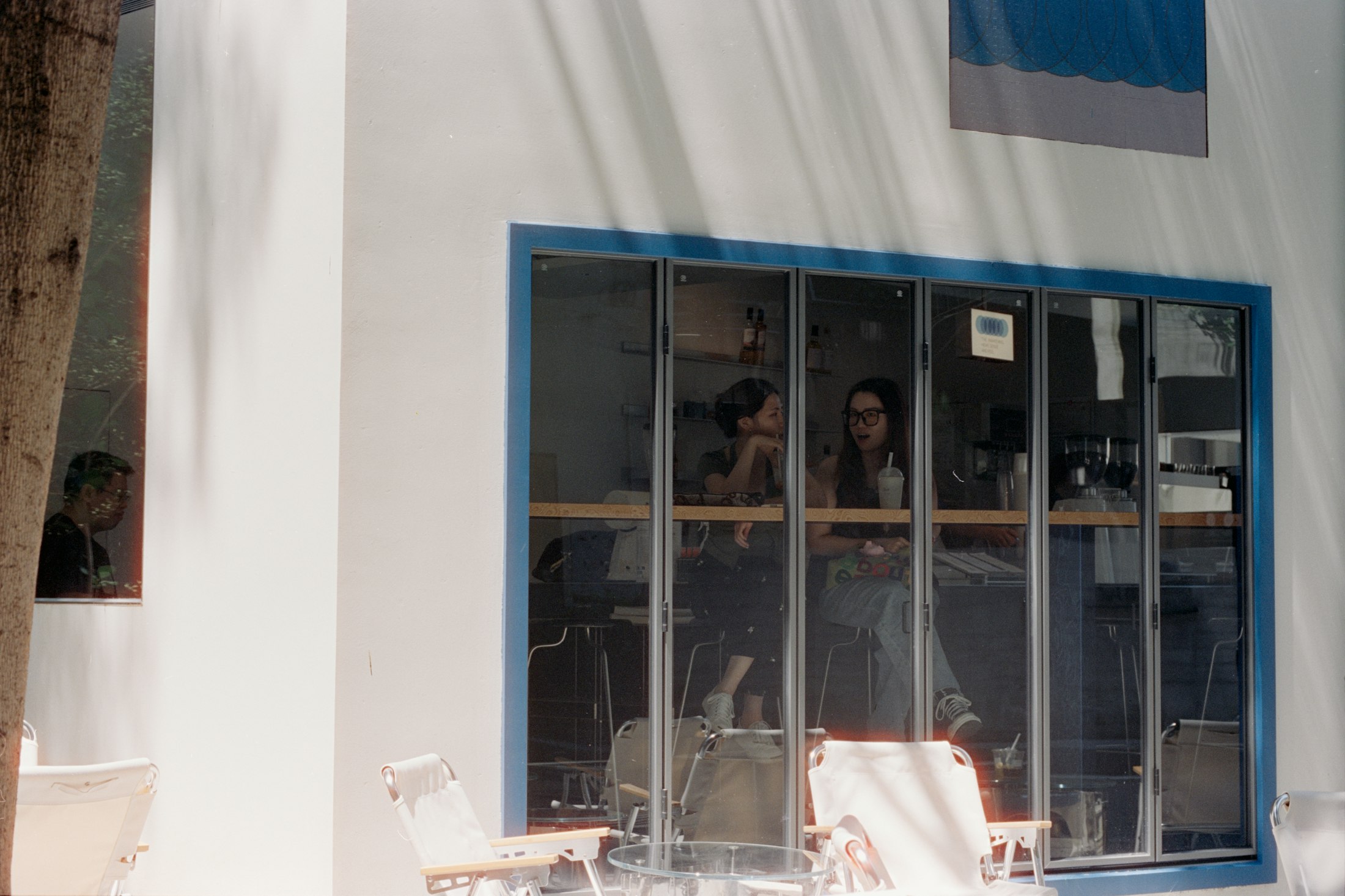 Guests seen through a large café window from the street