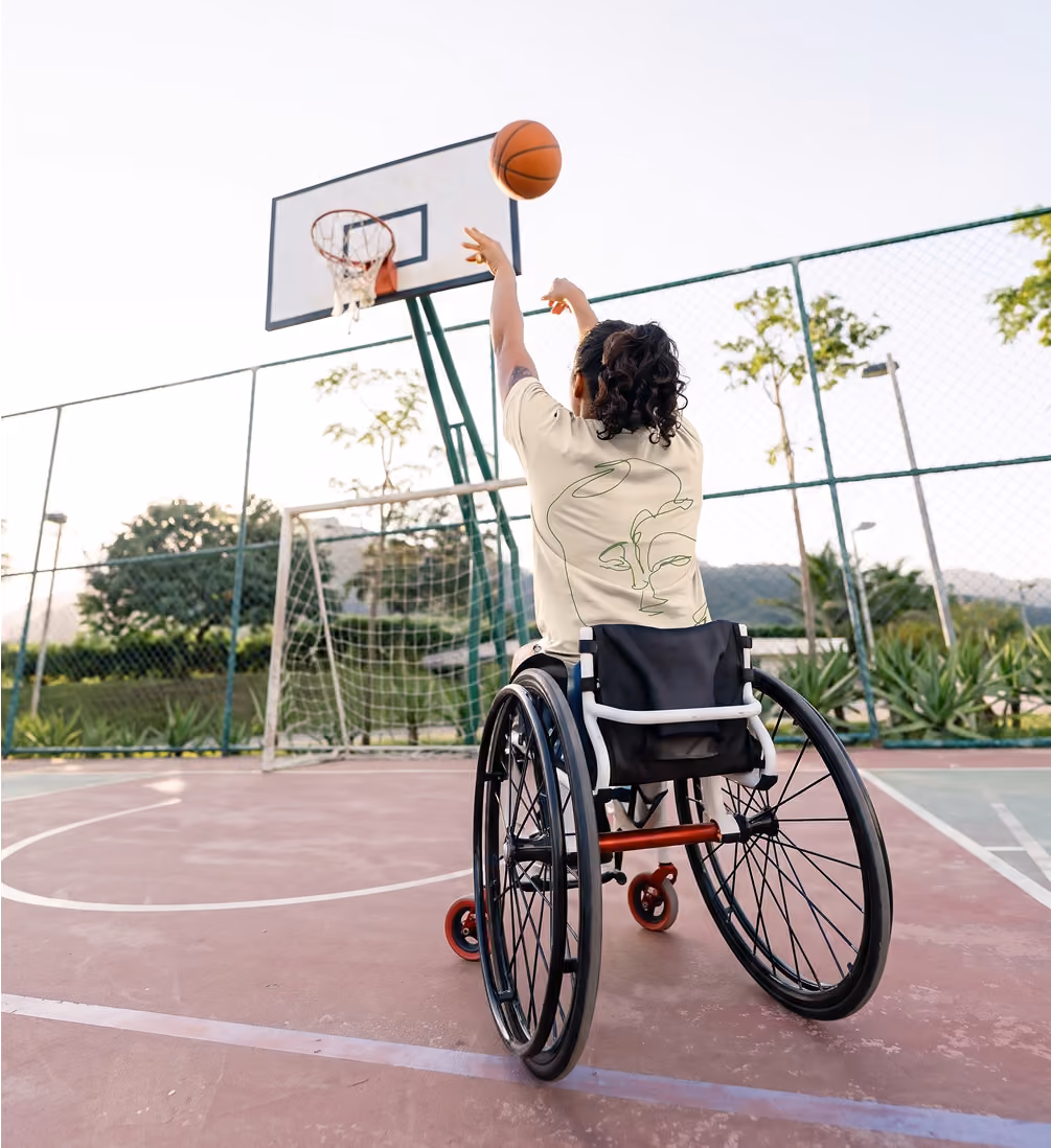 A wheelchair basketball player wearing a cream T-shirt with Bevica’s continuous-line portrait illustration.
