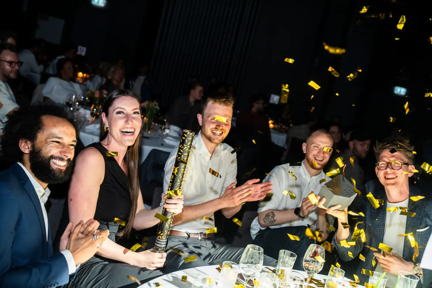 Kvalifik team celebrating a Danish Digital Award with gold confetti.