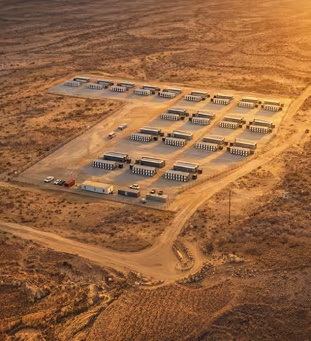 Aerial golden-hour view of an expansive modular MARA data center and containerized mining facility in an arid landscape.