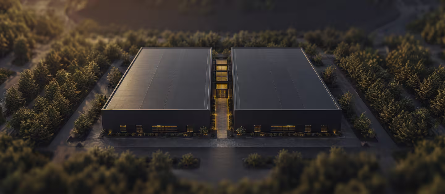Aerial rendering of twin dark-clad MARA data center buildings with a central entrance spine, set among forested grounds at dusk