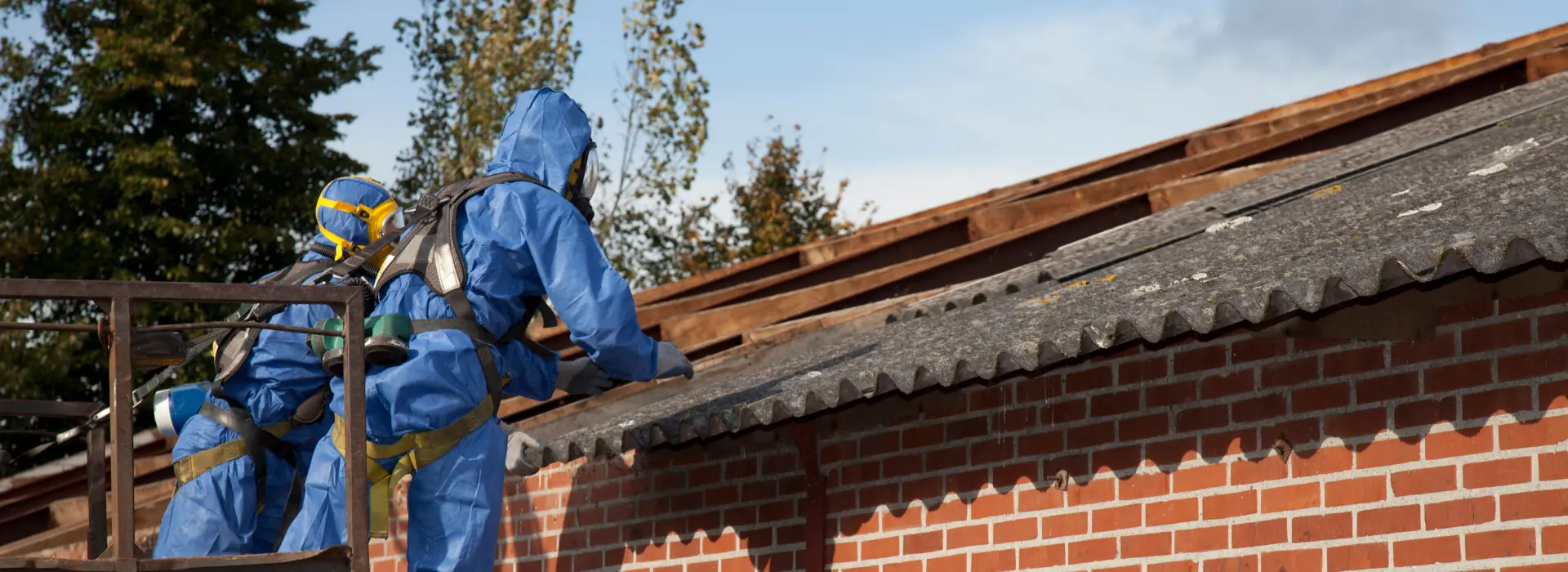 Flocage dégradé sur une poutre dans un local commun d'immeuble