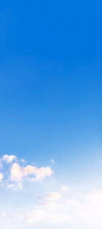 Clear blue sky with a few scattered white clouds near the bottom.