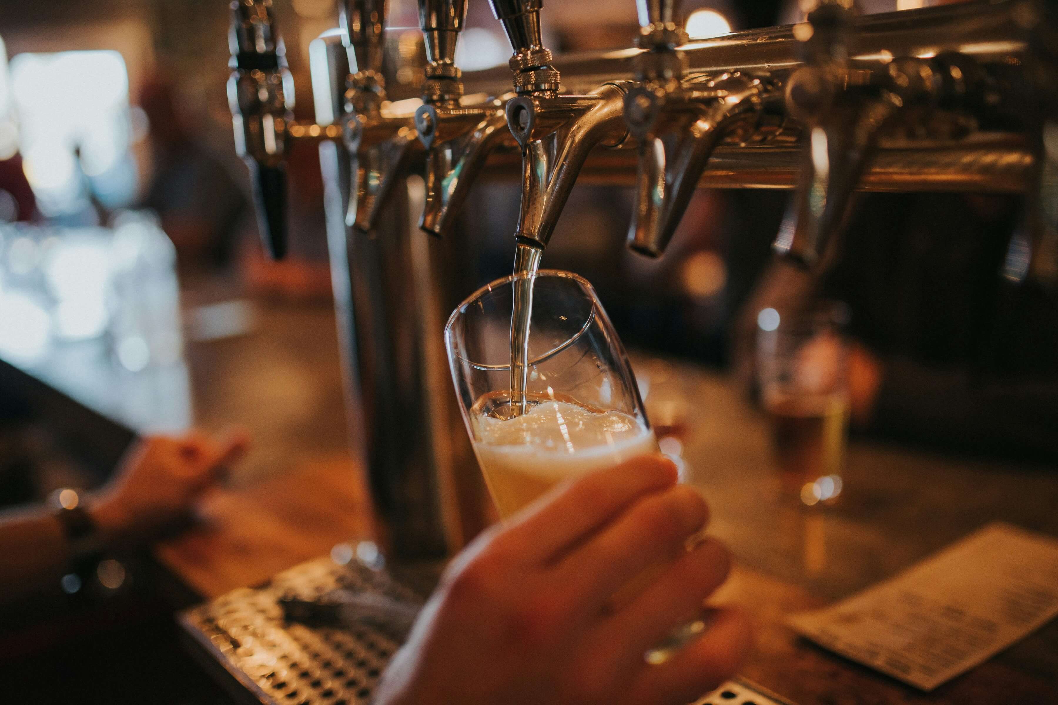 A bartender pouring draft beer