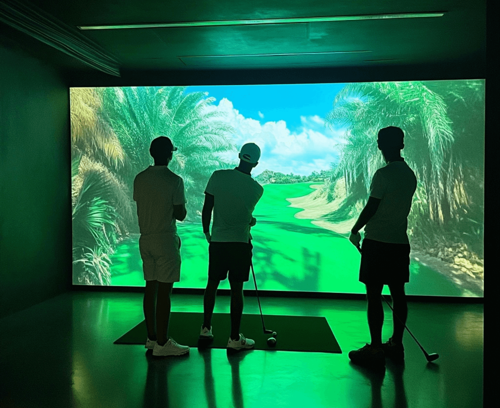 3 People using an indoor golf simulator
