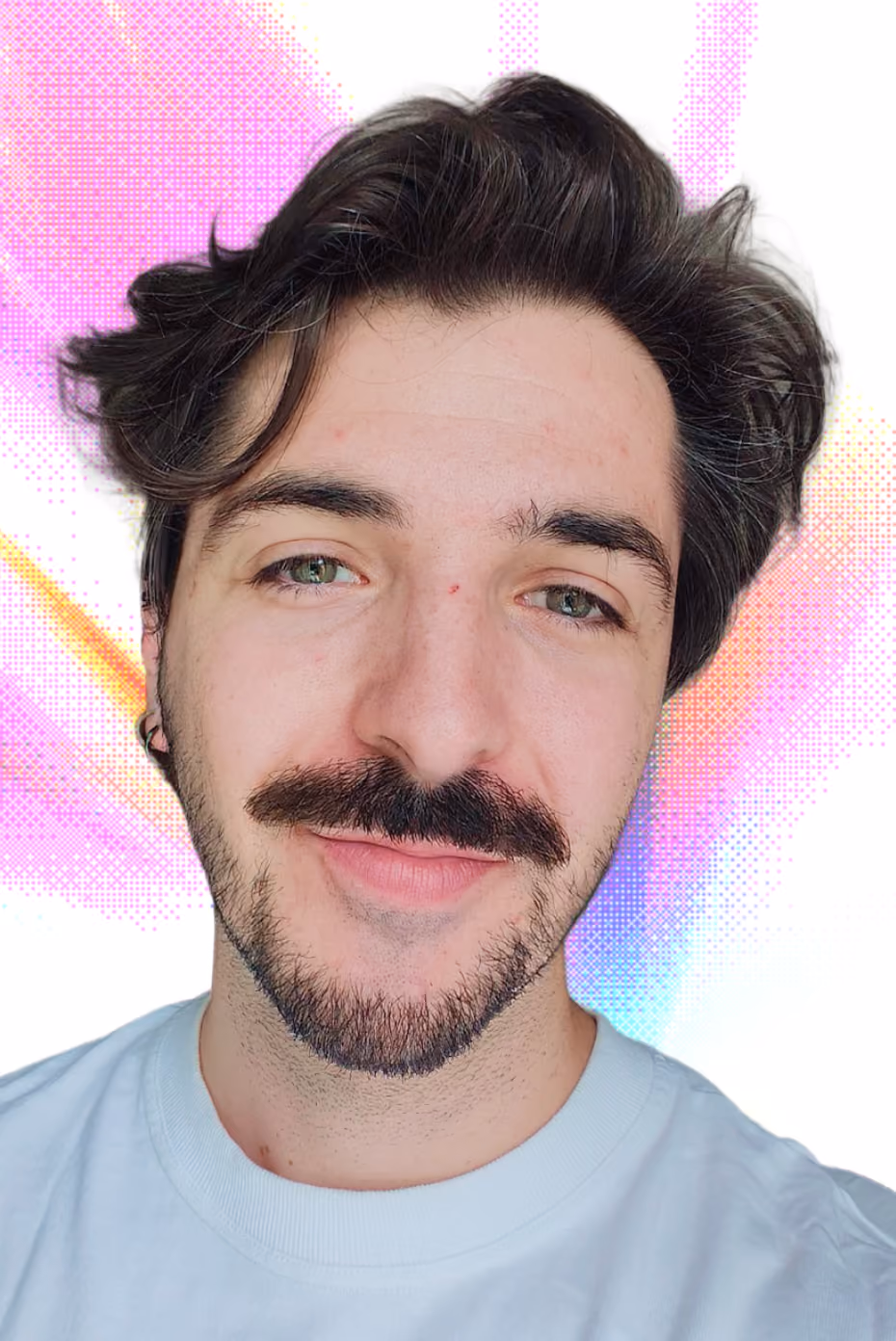 Gros plan d'un homme souriant avec une moustache et une barbe courte, cheveux foncés coiffés en arrière, portant un t-shirt blanc, avec un fond artistique aux couleurs violet, orange et bleu.