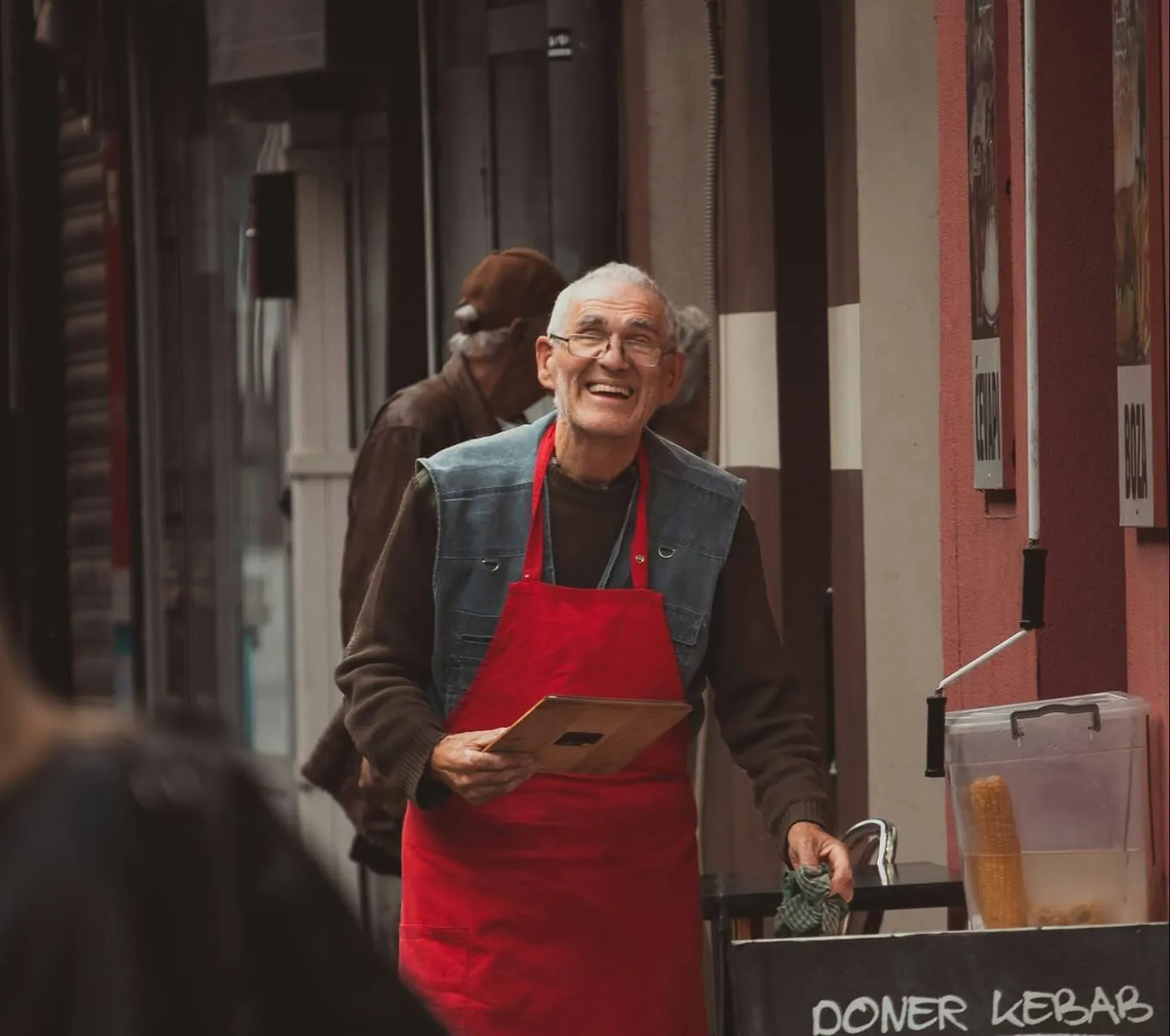 A small business owner outside their shop