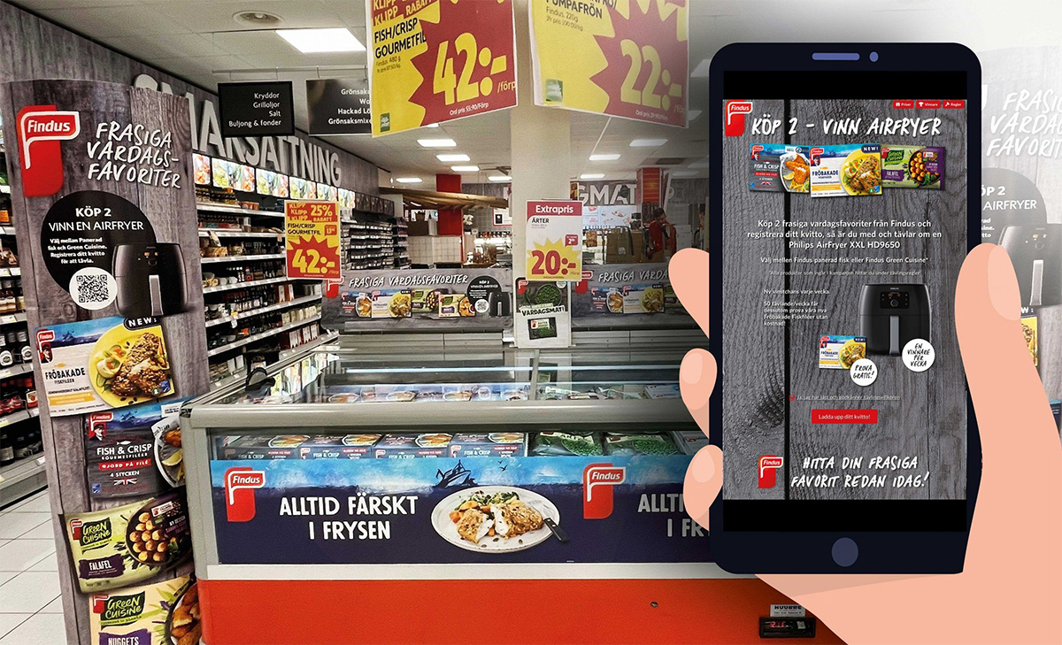 Mobiltelefon med en kupong framför en frysdisk
