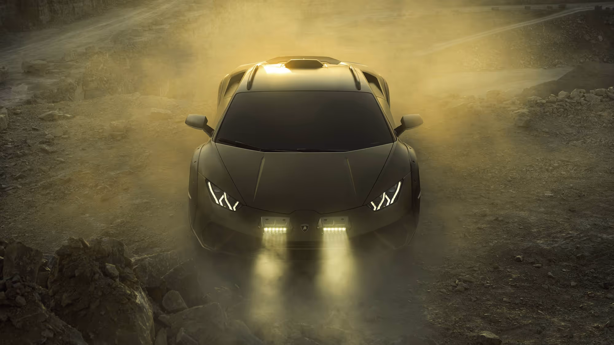 Lamborghini with headlights on parked in front of a rocky landscape.