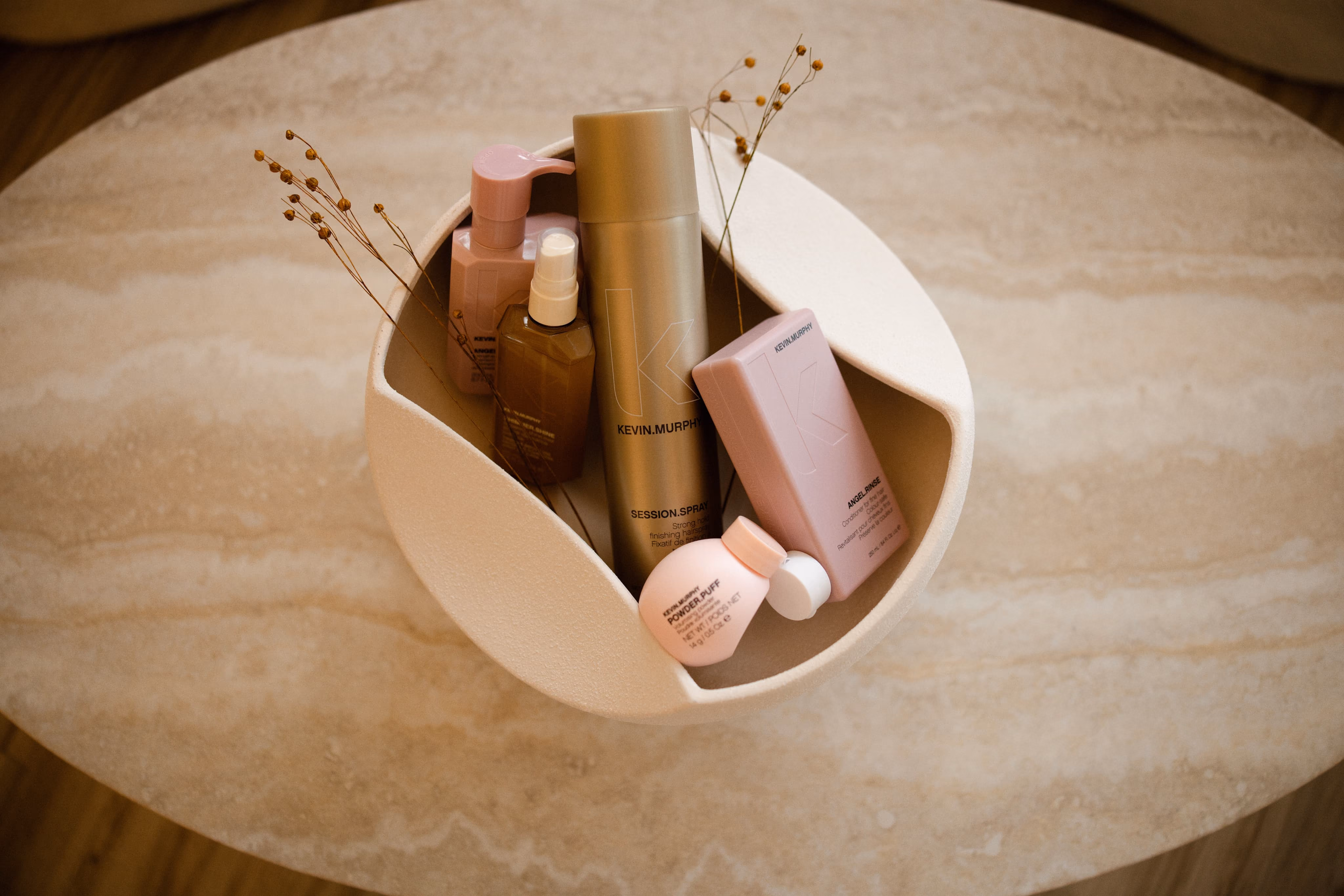 Curved stone dish holding makeup and skincare products
