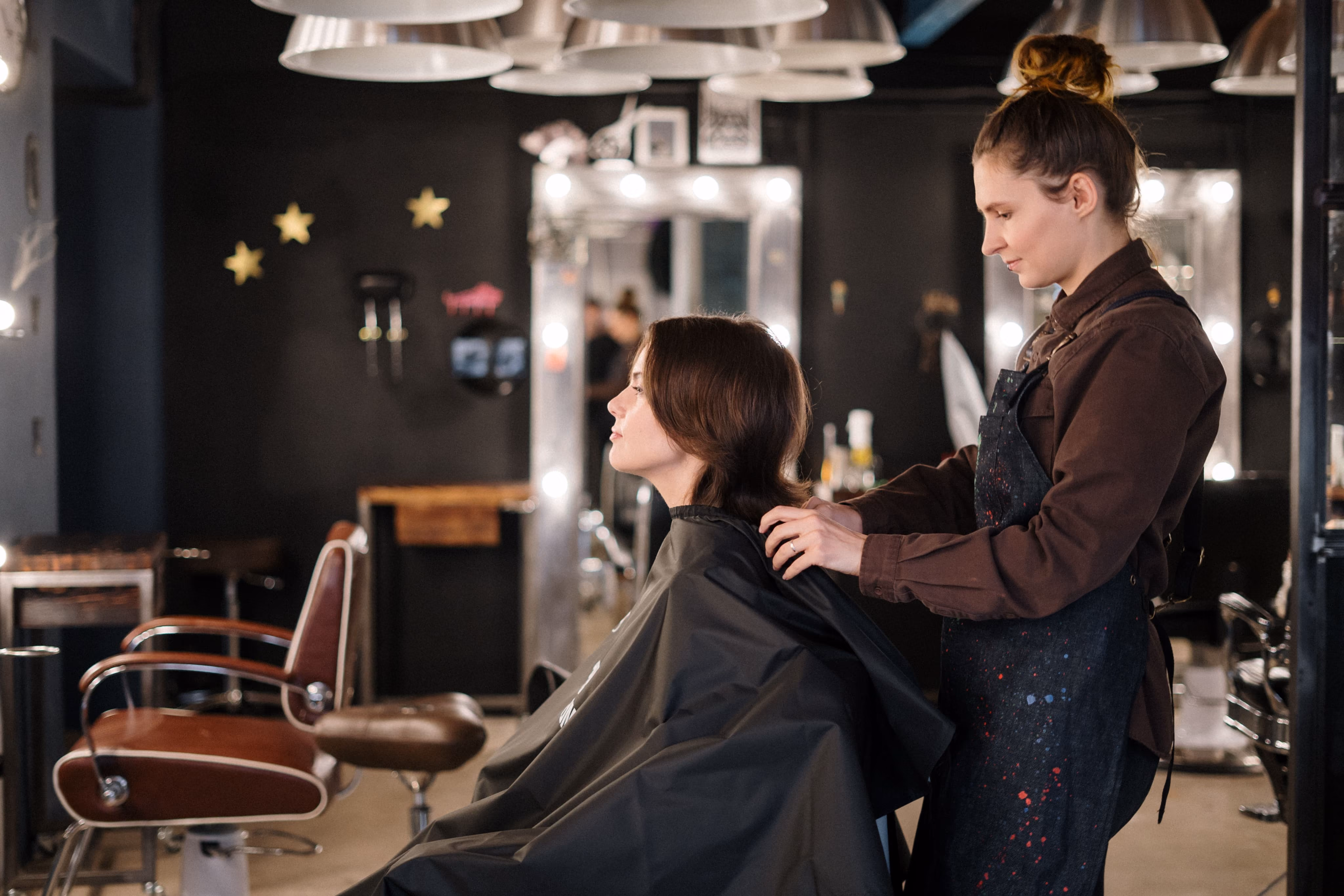 Stylist working on a client at the styling chair in the salon