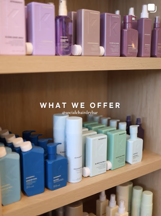 Shelves of professional haircare products on the retail wall at The Social Chair