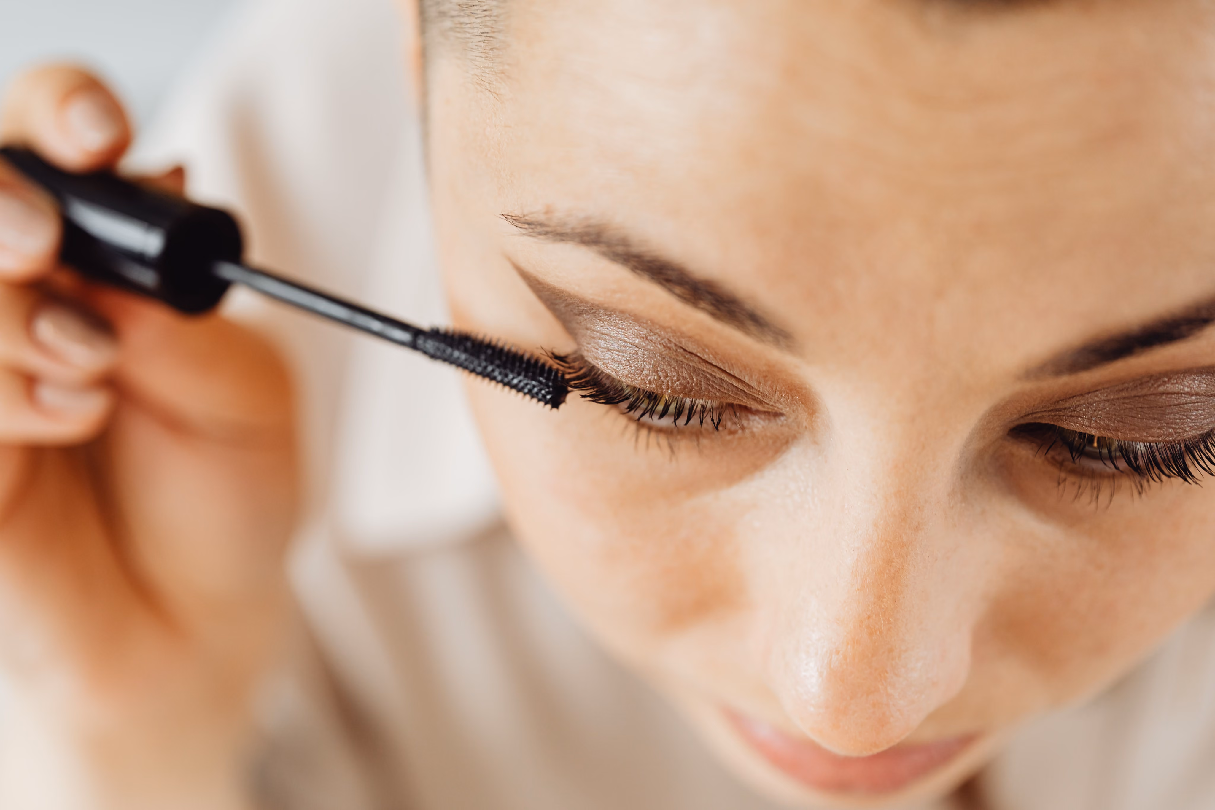 Makeup artist applying mascara to a bride on her wedding morning