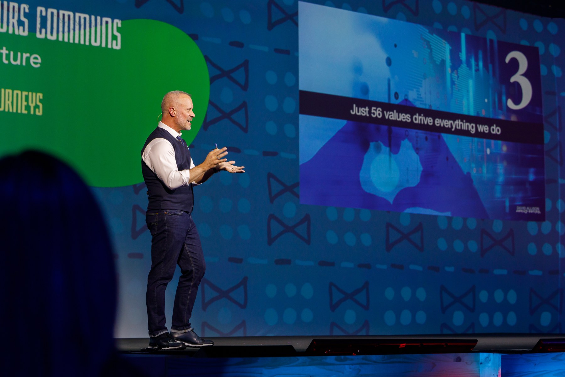 David Allison speaking on stage in front of a keynote slide