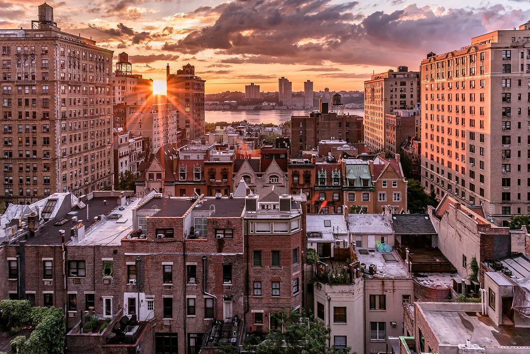 Sunset over Manhattan rooftops and brick apartment buildings