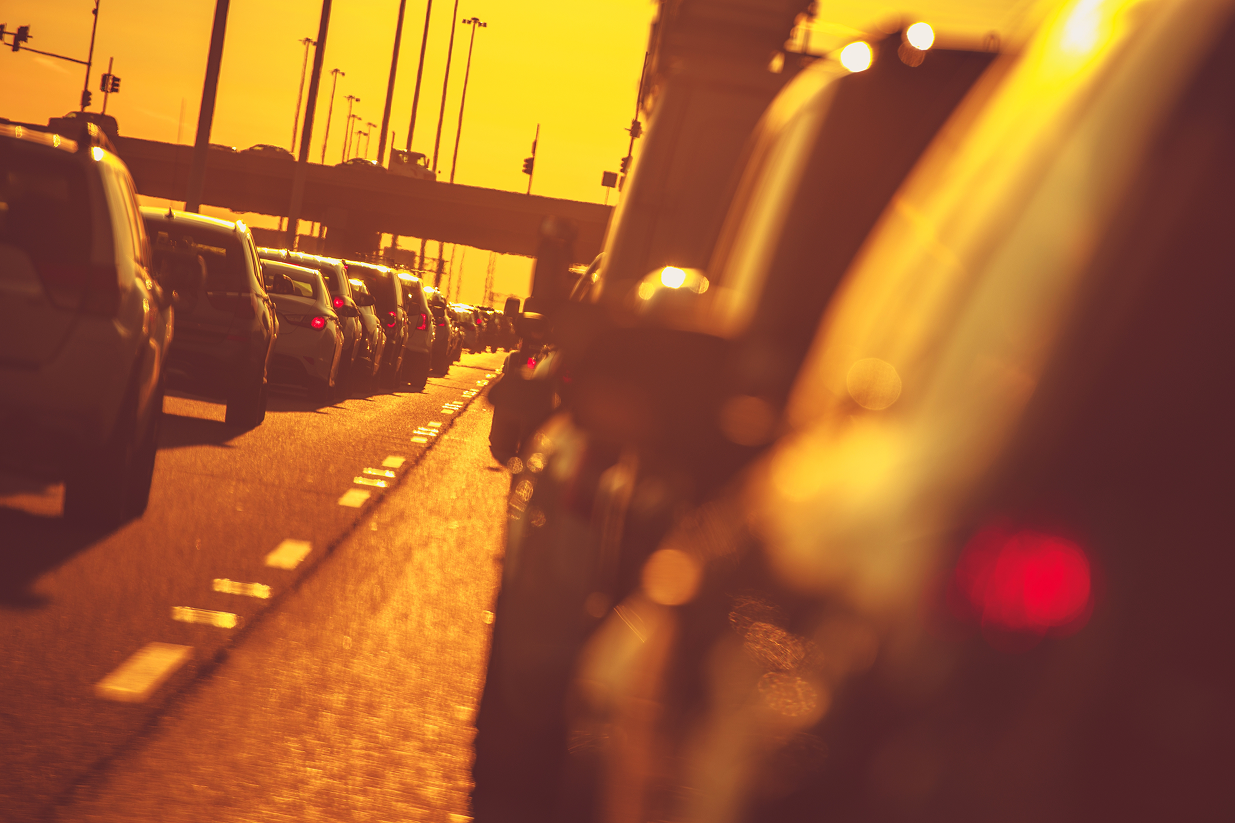 Traffic on a sunlit city street at golden hour