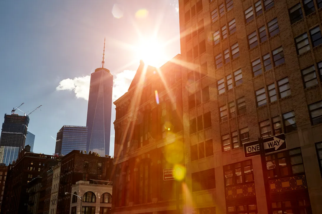 Sunlight flaring between Lower Manhattan towers near One World Trade Center
